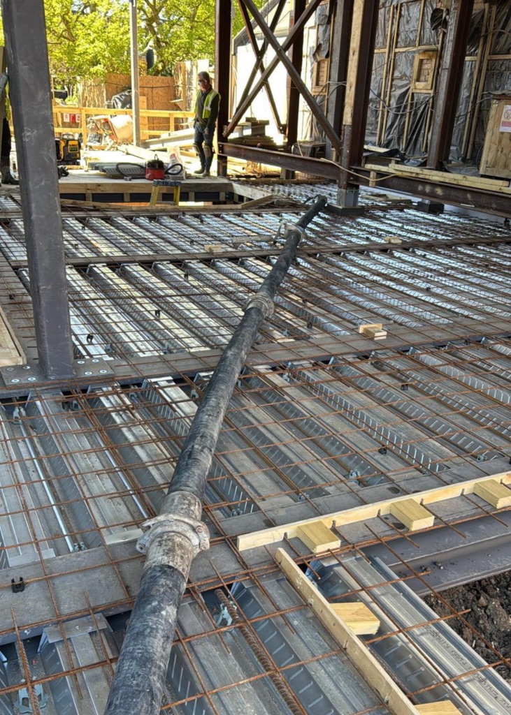 A King Concrete Pumping line pump feeding concrete on site near Clapham